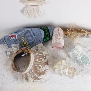Detailed flat lay of children's lace-edged straw hats in brown pink green and beige