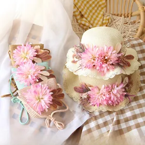 Detail of straw hat and mini crossbody bag set with floral accents for girls