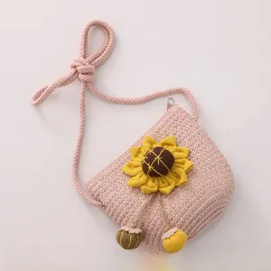 Detail of pink woven straw crossbody bag with 3D sunflower and adjustable strap for kids