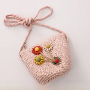 Detailed close-up of a pink woven flower crossbody bag for girls with cute ladybug charm
