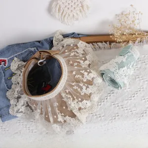 Detail of summer straw sun visor for girls with floral lace embroidery in beige and green
