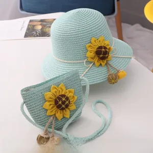 Detail of light blue straw sun hat and matching sunflower crossbody bag for girls