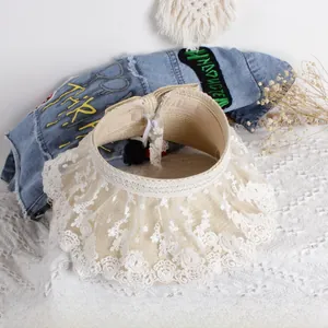 Detailed top view of kids straw hat featuring elegant white lace trim and elastic strap