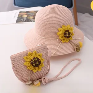 Close-up of pink sunflower straw hat and matching mini straw bag set for girls