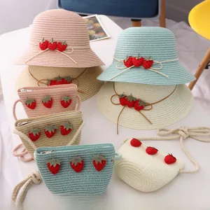 Vue à plat de chapeaux de paille enfant et sacs fraise assortis en quatre coloris pastel