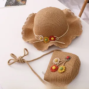 Close-up of children straw hat and bag set with colorful flower accents and ladybug detail
