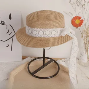 Close-up of children straw hat featuring elegant white lace ribbons and floral textures