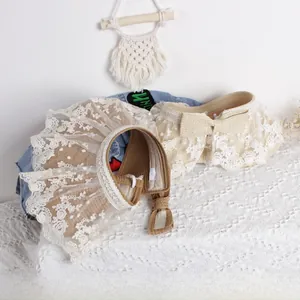 Detail of wide lace embroidery edge on woven straw open top sun hats for girls