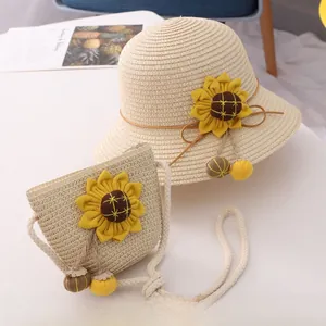 Detail of straw sun hat and matching bag with sunflower decoration and colorful tassels