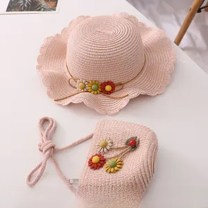 Close-up of pink straw hat and flower bag set with delicate wavy edges and ladybug charm