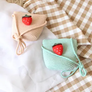 Handmade strawberry straw crossbody bags for kids in apricot and light green summer colors