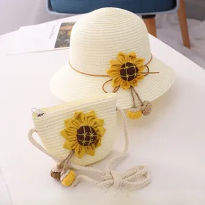 Detail of girls straw sun hat and matching crossbody bag with yellow sunflower accents