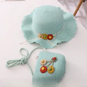 Detail of mint green woven straw hat and matching flower bag set for kids' summer beach trips