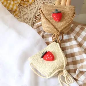 Handmade strawberry straw crossbody bags for kids in light beige and dark khaki colors