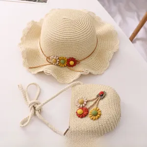 Detail of cream woven sun hat and floral bag set with colorful handmade 3D flower accents