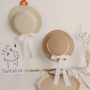 Handwoven straw sun hat for girls with delicate white lace trim and bow decorations