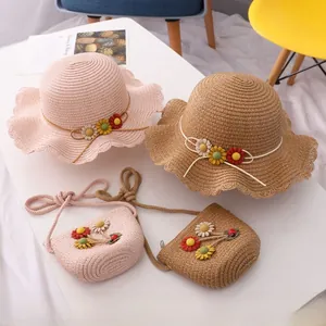Detailed close-up of straw sun hat and matching bag with sunflower accents for kids