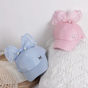 Kids baseball cap with pearl bow and metal M letter in pink and blue pastel colors