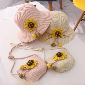 Detail of pink and beige sunflower straw hat set with matching woven cross-body bag