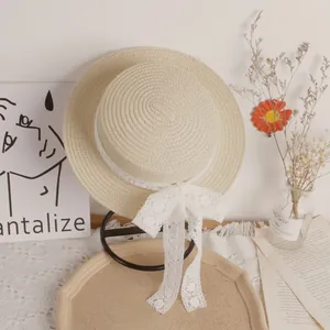 Straw sun hat for girls with delicate white lace floral ribbon and elegant bow accent