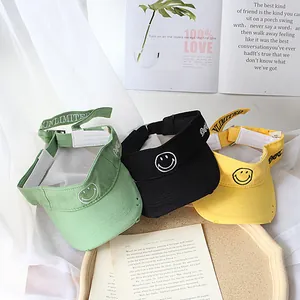Kids smile sun visors in yellow, green and black canvas with adjustable straps