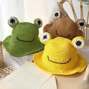 Detailed trio of handmade frog straw hats for kids in green, brown, and yellow colors