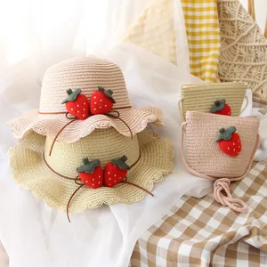 Straw sun hat and matching crossbody bag set with cute strawberry decor for toddlers