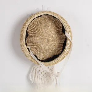 Close-up of woven straw hat interior featuring white lace trim and black sweatband