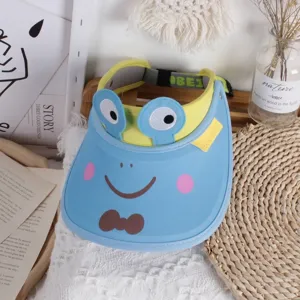 Detail view of children's frog sun hat with light blue brim and yellow elastic band