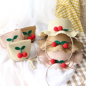 Kids straw sun hat and matching cherry crossbody bag set in beige and khaki tones