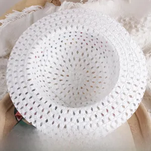 Detailed macro view of white woven straw hat with breathable hollow diamond texture