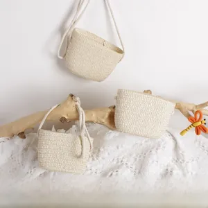 Detailed view of mini handmade straw crossbody bags with natural woven texture and straps