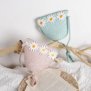 Cute straw woven crossbody bag for kids featuring embroidered daisies in pink and green