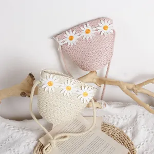 Cute children's straw crossbody bags with daisy appliques in beige and pink colors