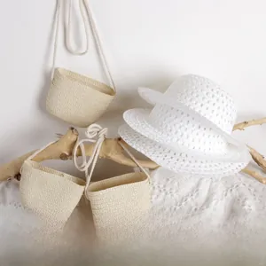 Detailed view of kids breathable hollow weave sun hat and mini straw bags set for summer