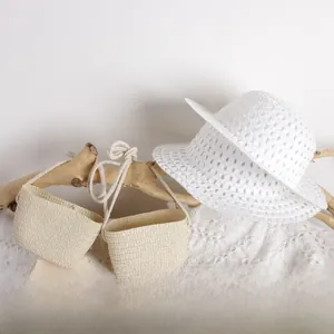 Detailed close-up of breathable white woven sun hat and beige straw bags for kids