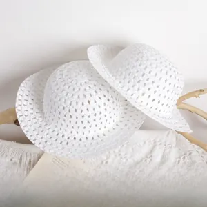 Detailed close-up of white breathable mesh sun hats with delicate ribbons for kids