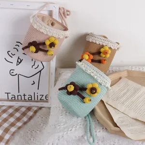 Lace-trimmed straw bucket bags for kids in pink, mint green and khaki with floral details