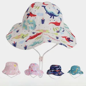 Detail of adjustable windproof rope and pink buckle on a colorful dinosaur kids sun hat