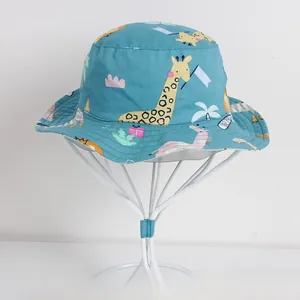 Detail of blue kids bucket hat with giraffe print and white adjustable chin strap