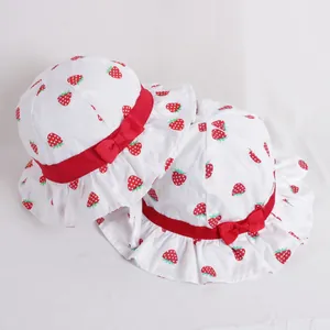 Set of two cotton baby sun hats with red strawberry prints and wavy ruffle brims