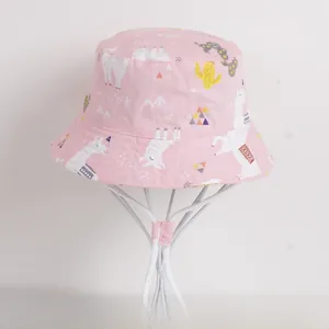 Close-up of pink cotton sun hat featuring cute alpaca and cactus cartoon prints