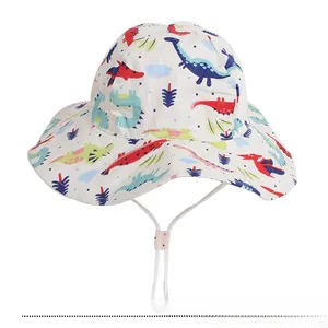 Detail of baby sun hat with colorful dinosaur pattern and white adjustable windproof cord