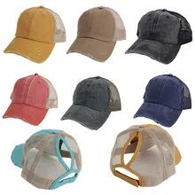 Detail view of washed cotton baseball caps showing distressed edges and ponytail opening holes