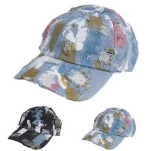 Detail of distressed tie-dye baseball cap with ripped holes and retro street style
