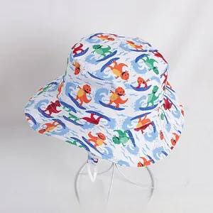 Detail of white cotton bucket hat with colorful cartoon dinosaur prints and chin strap