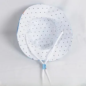 Detail of cotton kids bucket hat showing blue polka dot lining and adjustable chin strap
