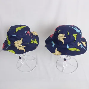 Detail of navy blue kids bucket hat featuring colorful dinosaur prints and adjustable chin strap