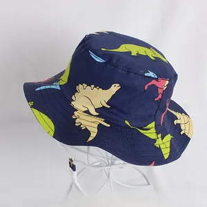 Detail of navy blue kids bucket hat with dinosaur prints and white adjustable chin strap