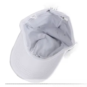 Detailed interior of a white cotton baseball cap showing stitching and fabric texture